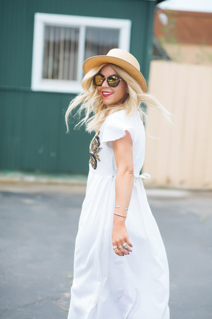 Lisa Allen of Lunchpails and Lipstick wearing a white somedays Lovin midi dress, with a jeans leone hat, mii mii glasses and coach sandals